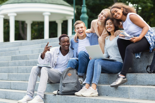5-college-students-and-one-of-them-is-holding-a-laptop